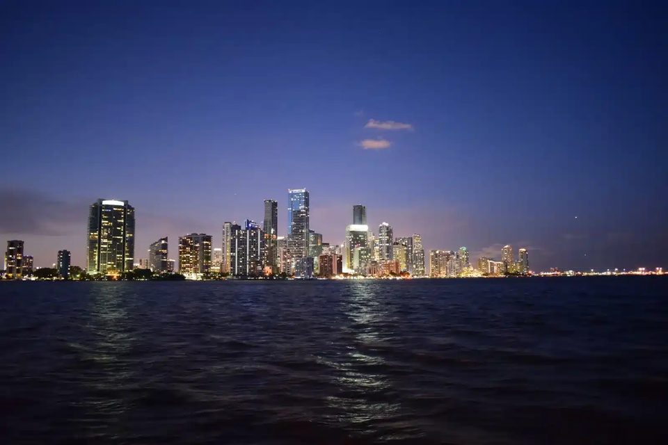 Miami skyline at dusk across the calm water of Biscayne Bay