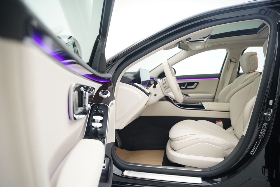 Cream leather seats inside a Mercedes-Maybach, seen through the open door