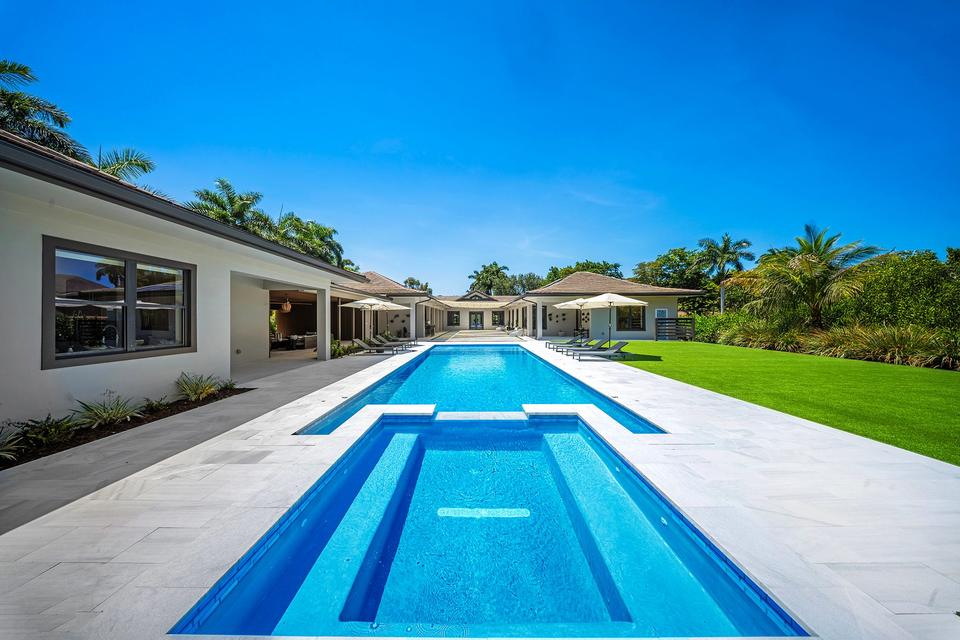 Villa Banyan long pool and lawn under a blue sky, Sunny Isles Beach