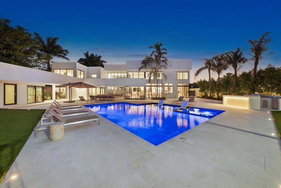 Villa Palma illuminated pool and villa at twilight, Miami luxury rental