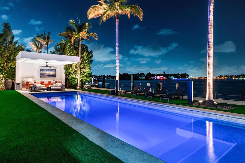 Lap pool at night with the bay beyond, Villa Lavoro, Miami Beach luxury rental