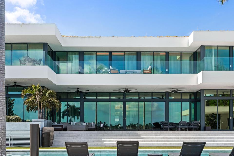 Modern white facade with floor-to-ceiling glass, Villa Lavoro, Miami Beach luxury rental