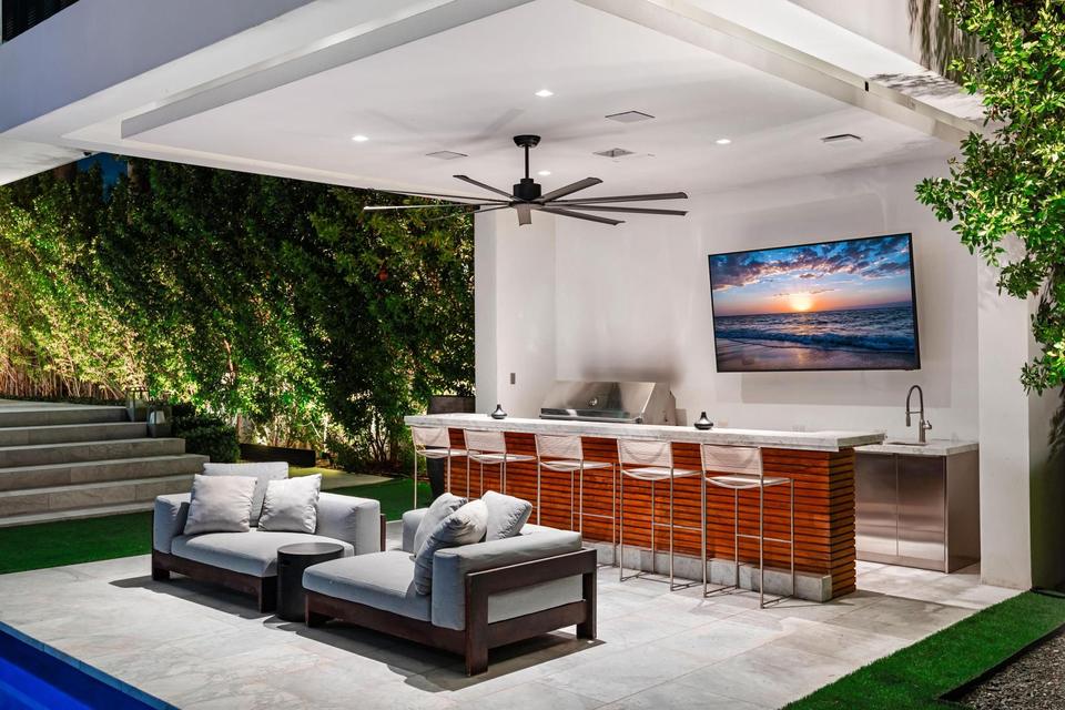 Outdoor lounge and bar with television, Villa Lavoro, Miami Beach luxury rental