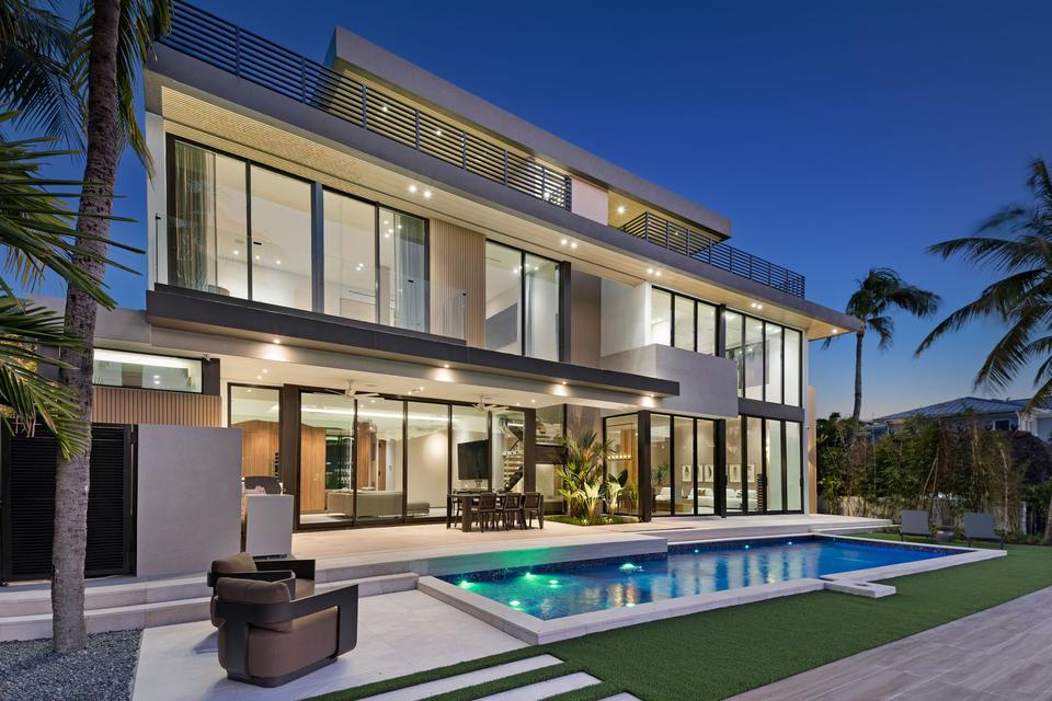 Villa Sia modern waterfront villa and pool at dusk, Las Olas Isles, Fort Lauderdale luxury rental