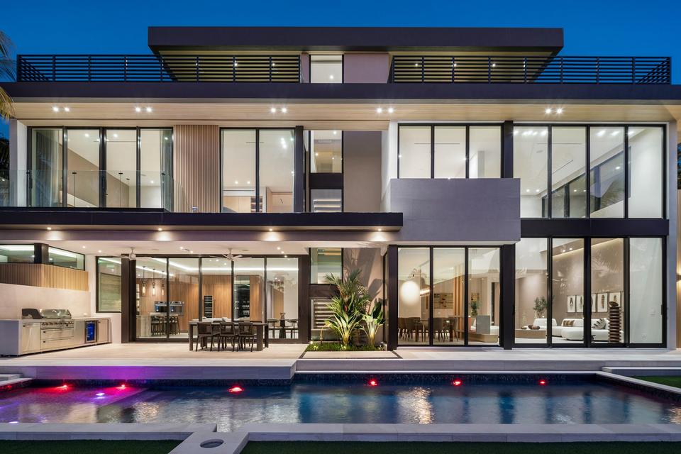 Pool and glass rear facade lit at night, Villa Sia, Las Olas Isles, Fort Lauderdale luxury rental