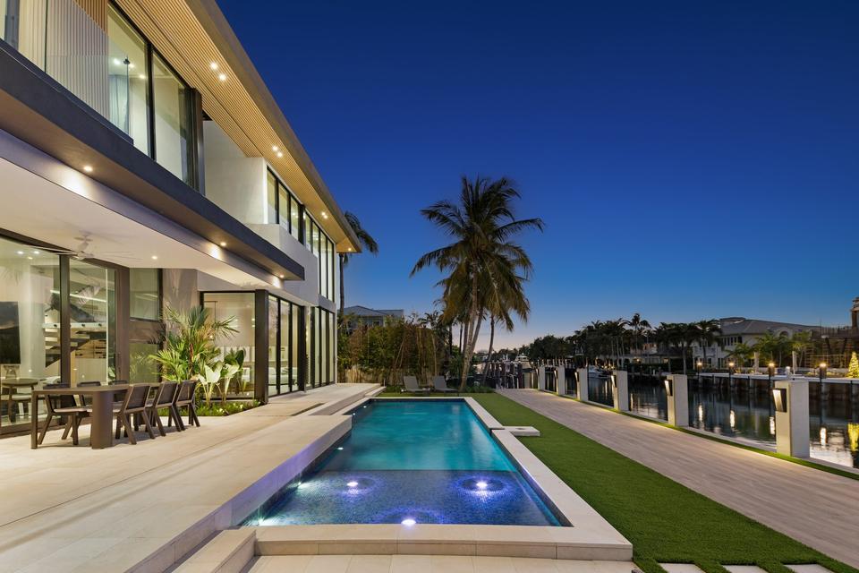 Lap pool at twilight beside the waterway, Villa Sia, Las Olas Isles, Fort Lauderdale luxury rental