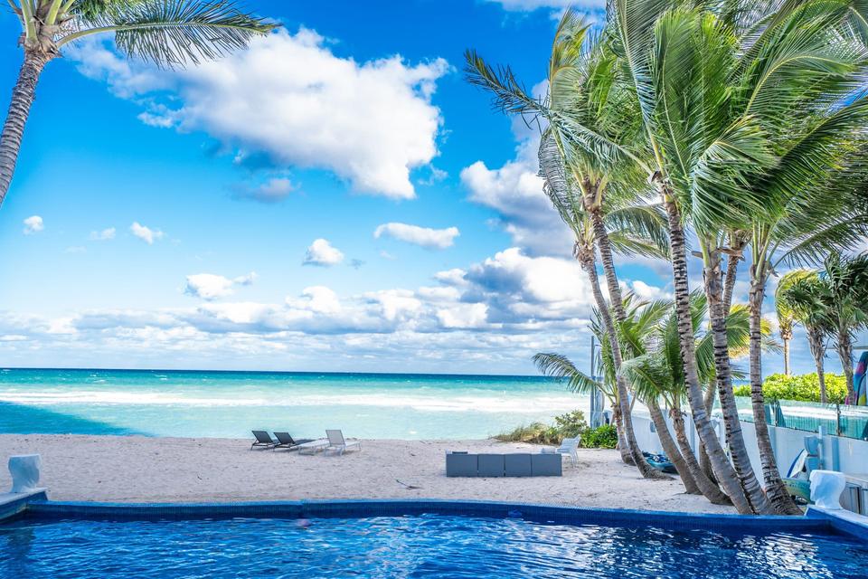 Pool and palms beside a quiet Miami beach