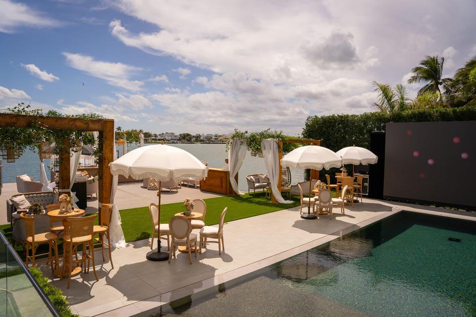 Poolside dining under white umbrellas, Miami villa