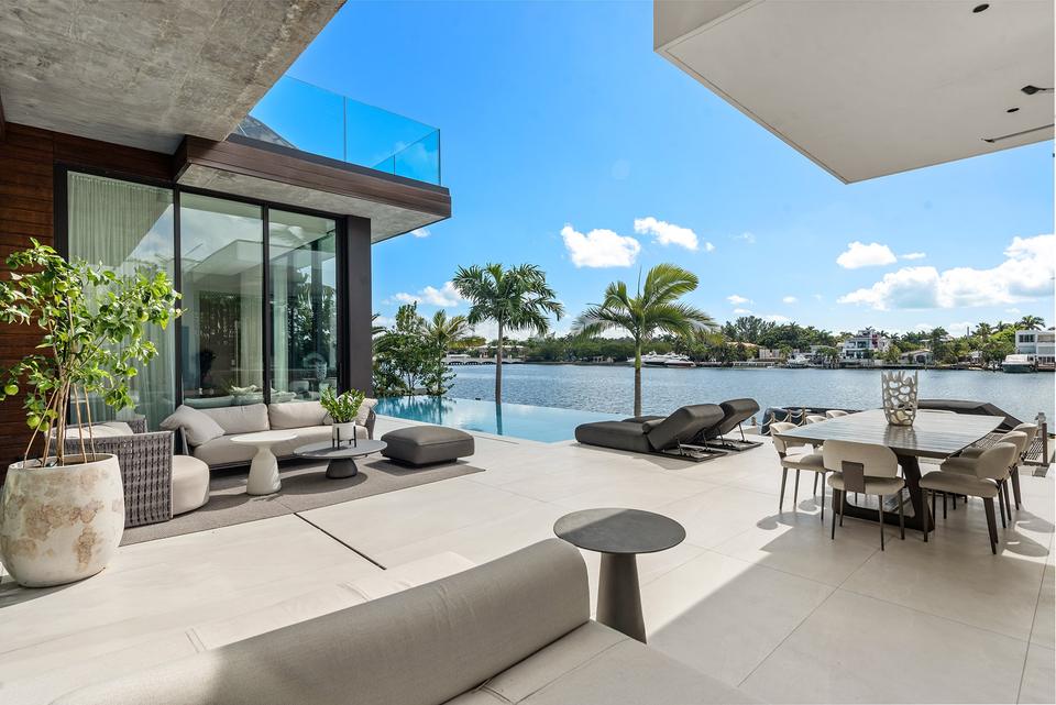 Covered terrace lounge overlooking the water, Miami villa