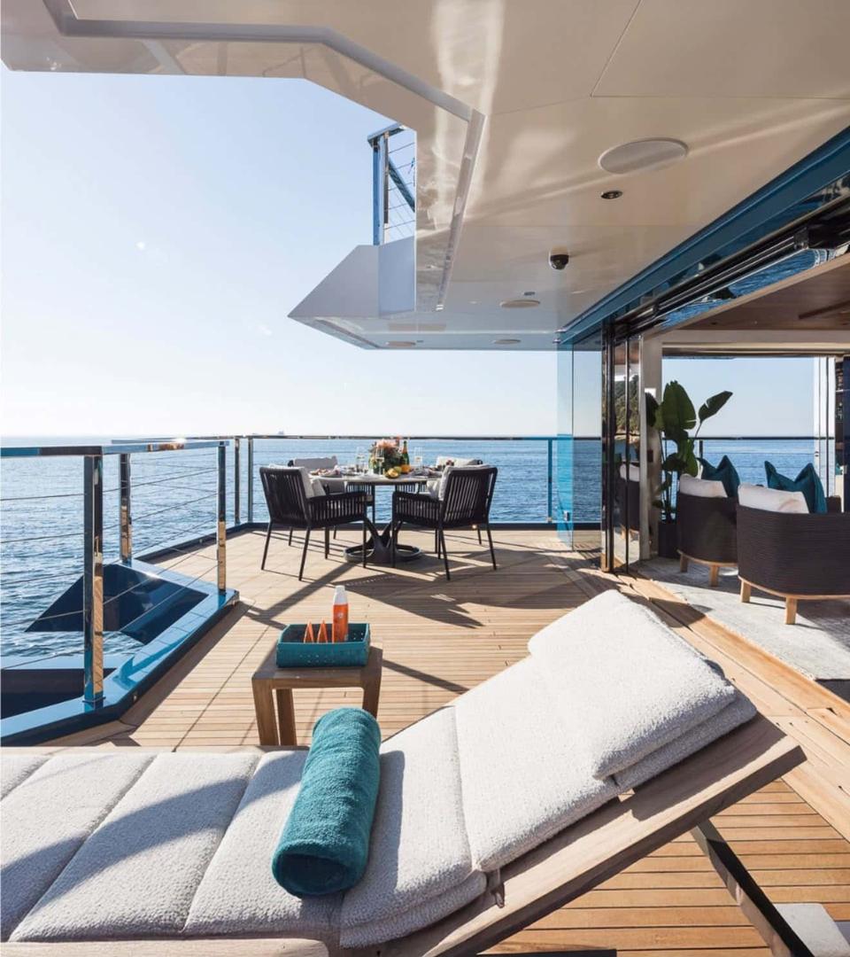 Aft deck lounge and dining table on a charter yacht