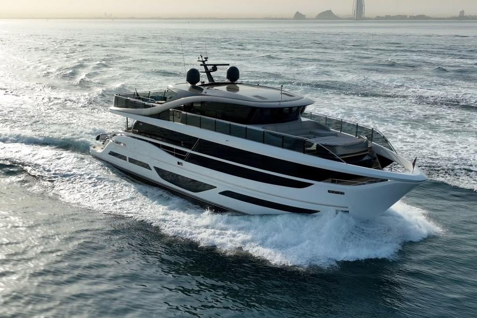 Black-hulled motor yacht cruising at speed, Miami