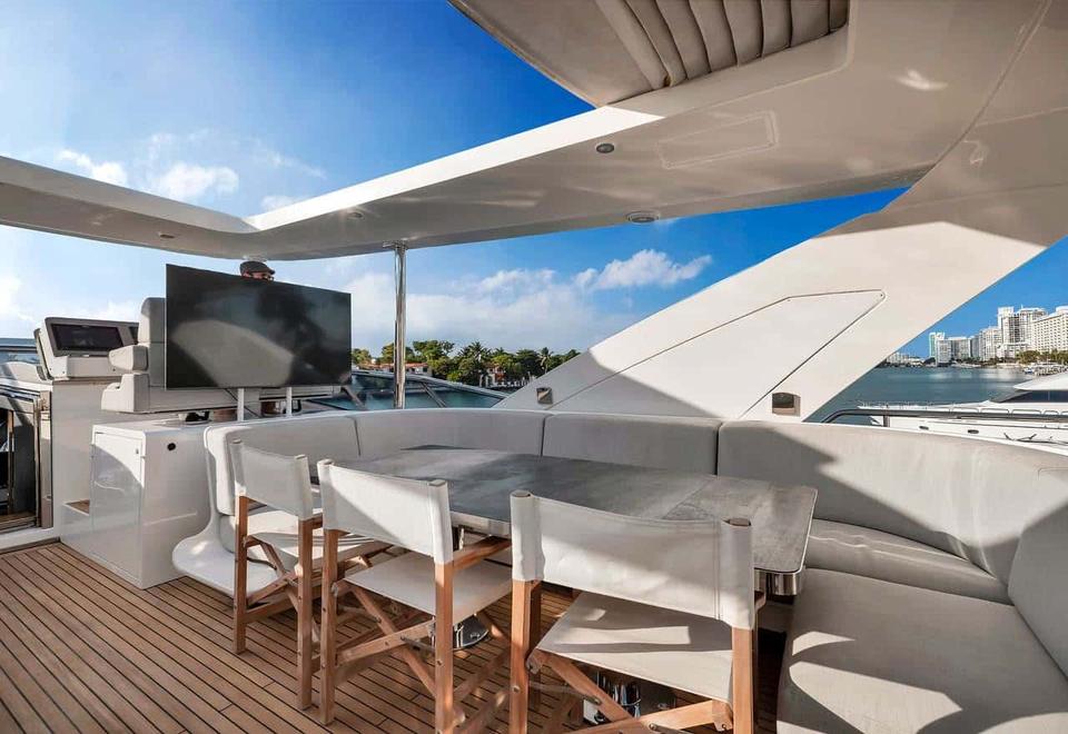 Upper deck dining table under the hardtop of a luxury yacht