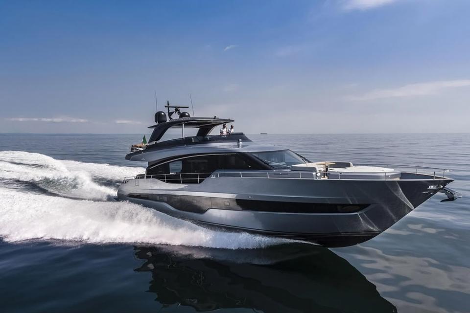 Flybridge motor yacht under way on calm water