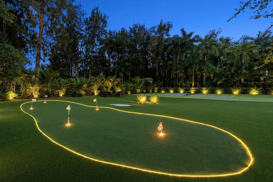 Villa Banyan putting green lit at dusk