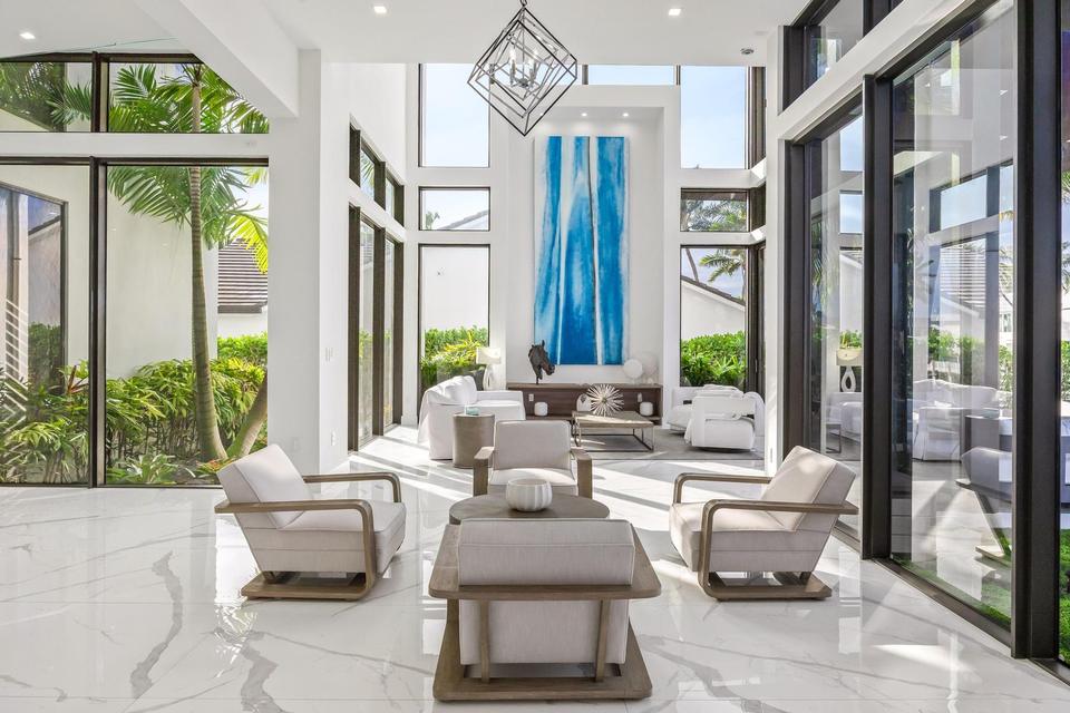 Lounge seating under double-height windows, Villa Estan, Eastern Shores, North Miami Beach luxury rental