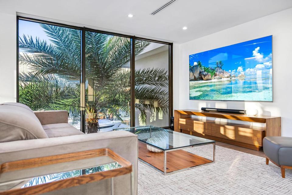 Family room with wide screen and garden views, Villa Estan, Eastern Shores, North Miami Beach luxury rental