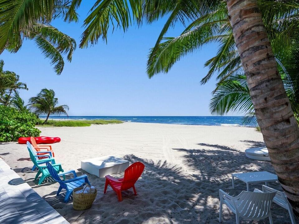 Private beach with chairs under the palms at Beach Bungalow