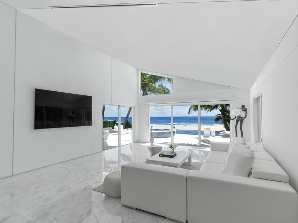 Bright living room with the ocean beyond the glass