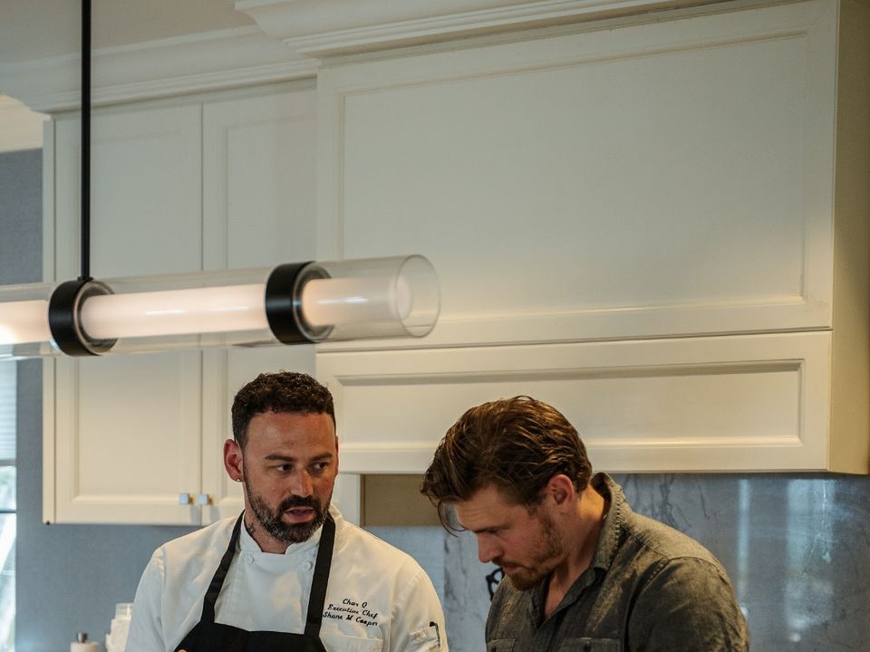 Private chef talking through a menu with guests