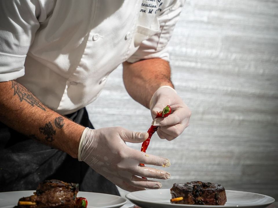 Private chef plating a dish