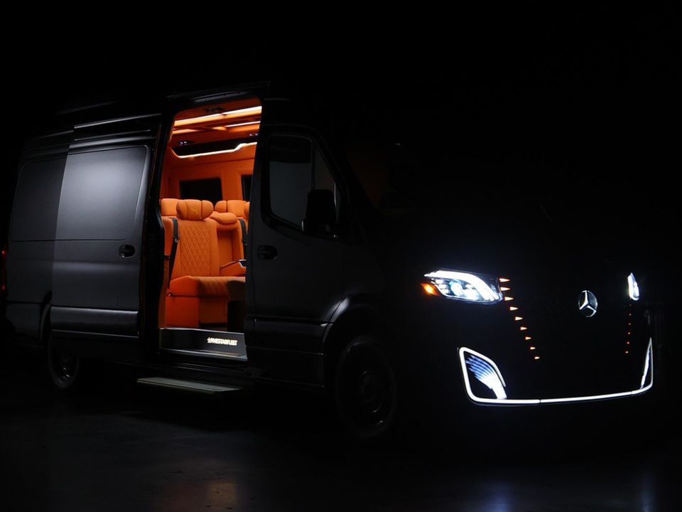 Mercedes Sprinter at night with a warm lit interior