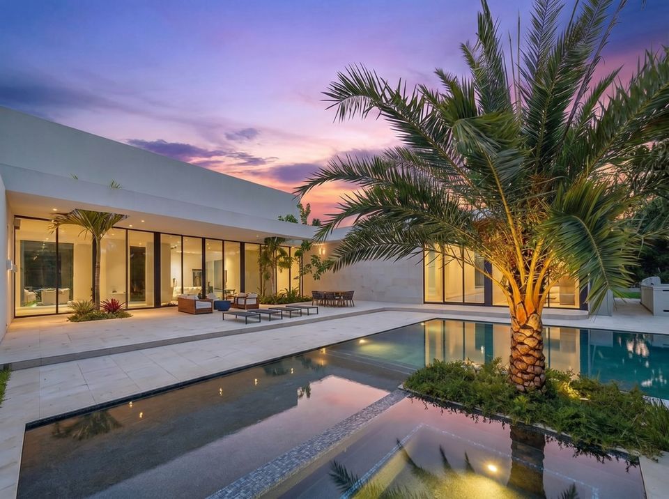 Lit courtyard pool with palms at dusk, Villa Verano, Southwest Ranches