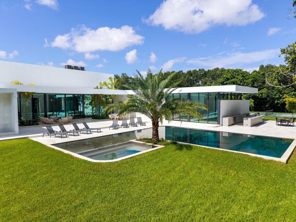 Pool, lawn and sun loungers on a sunny day, Villa Verano, Southwest Ranches