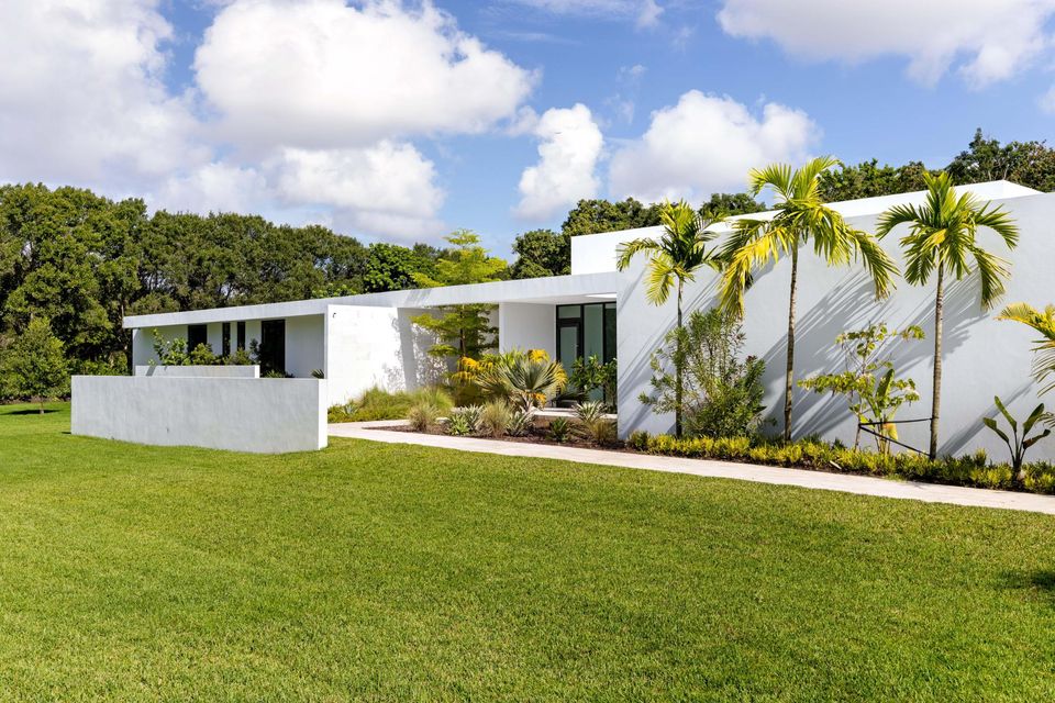 Side lawn with palms and the white modern facade, Villa Verano, Southwest Ranches
