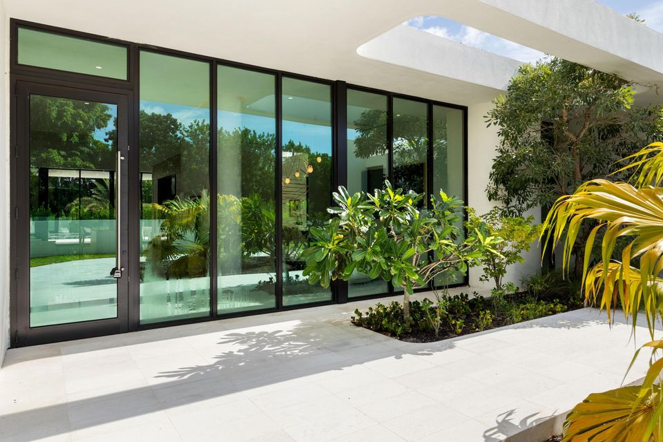 Glass walls opening to a planted courtyard, Villa Verano, Southwest Ranches