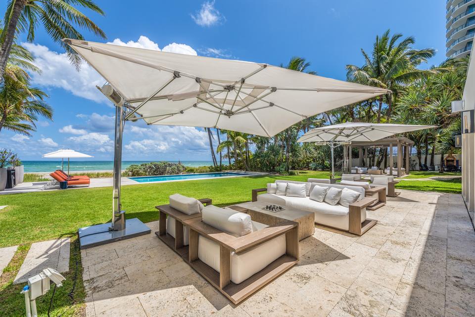 Outdoor lounge under white parasols, Villa Ocean, Miami