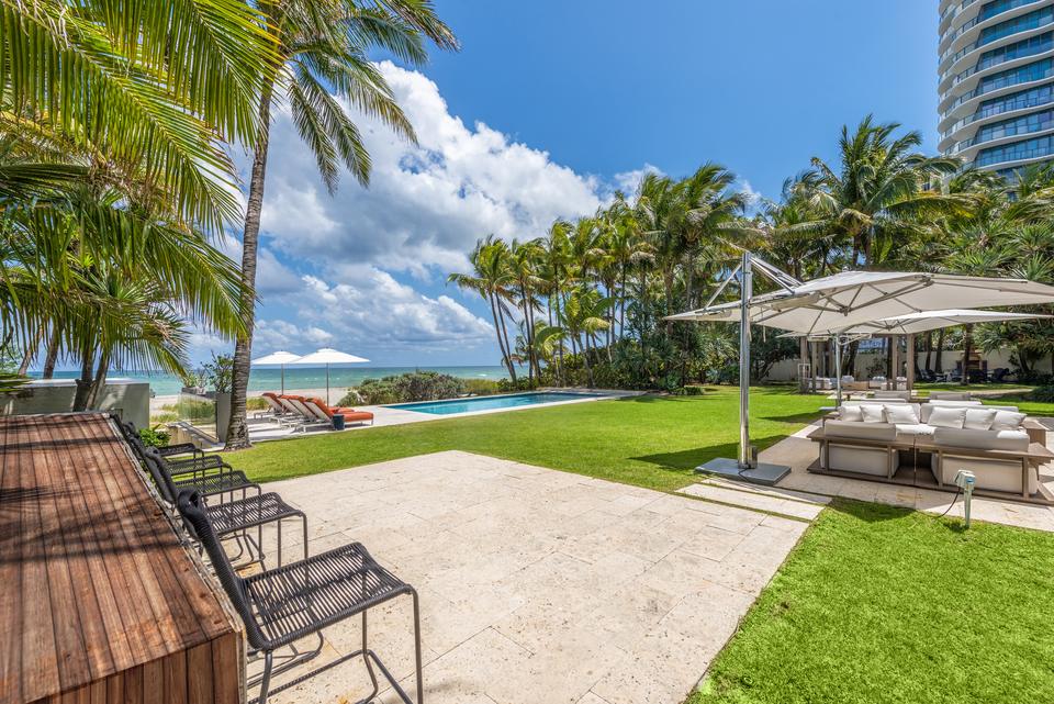Garden path and lawn lounges toward the sea, Villa Ocean, Miami