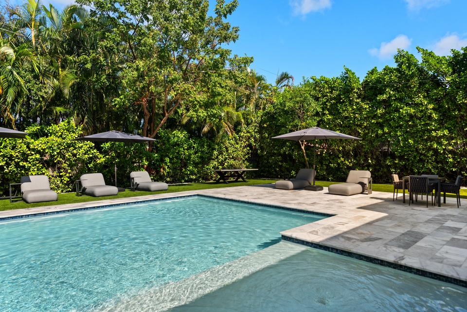 Pool deck with loungers and parasols, Villa Meimon, North Miami Beach