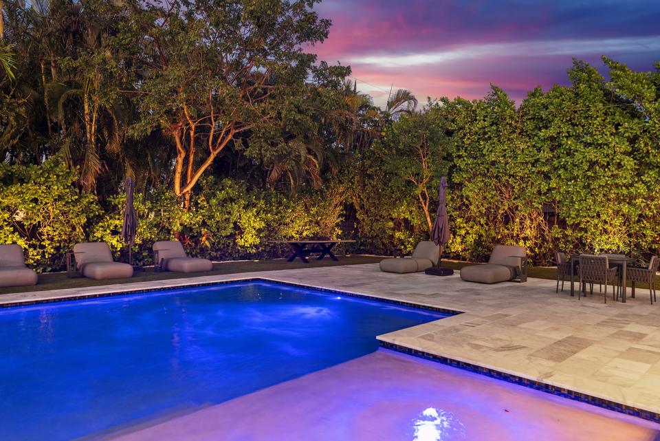 Pool and garden lit at twilight, Villa Meimon, North Miami Beach