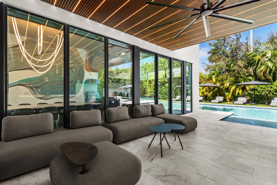 Covered outdoor lounge facing the pool, Villa Meimon, North Miami Beach