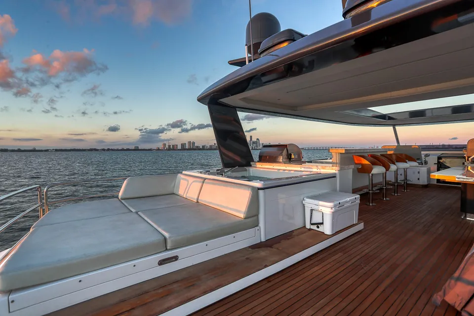 Shaded aft deck of the Sirena 88 yacht with lounge seating and open water views