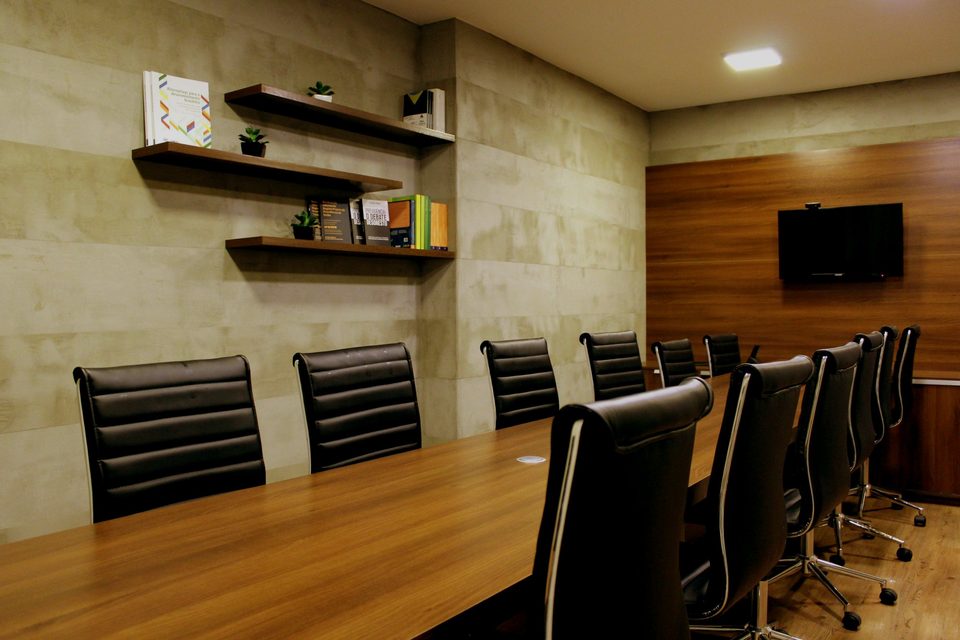 Boardroom with black leather chairs around a long table