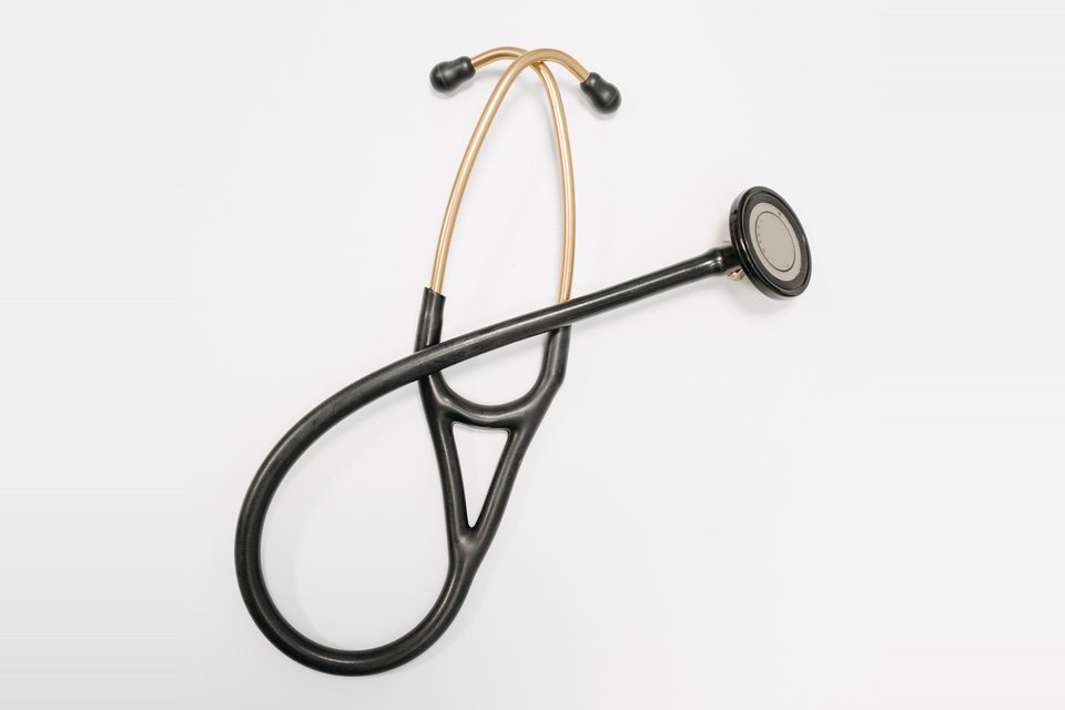 Stethoscope with gold tubes on a clean white surface