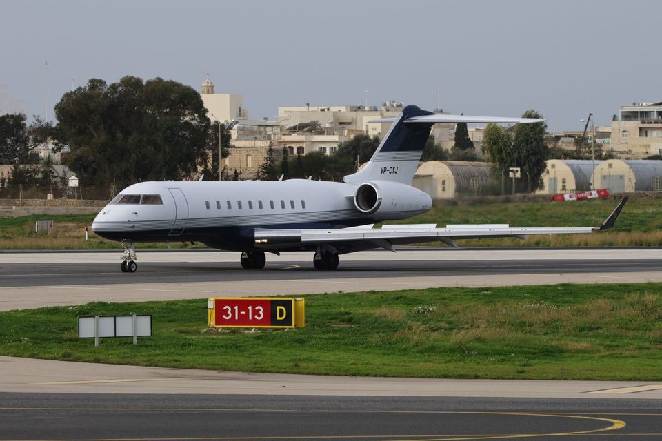 Private jet taxiing on the runway on a clear day