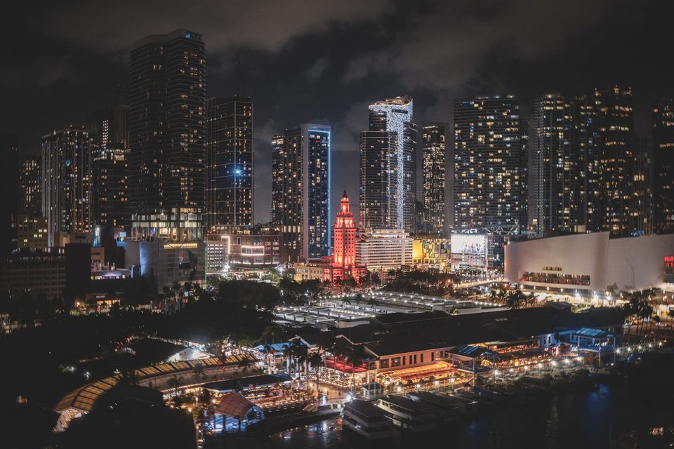 Downtown Miami skyline lit up at night over Biscayne Bay
