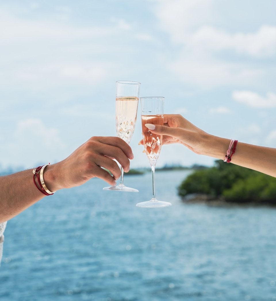 Champagne toast over blue water on a sunny South Florida day