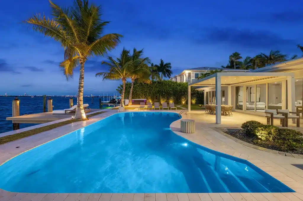 Villa Venetian bayfront pool and covered terrace at dusk, Venetian Islands, Miami Beach