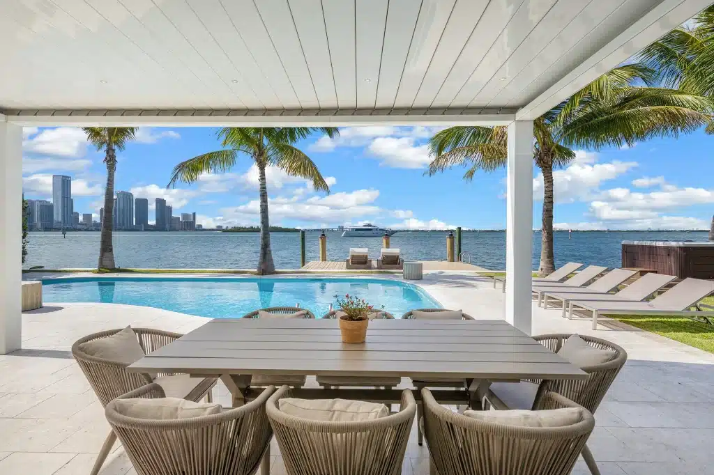 Covered outdoor dining terrace overlooking the pool and bay, Villa Venetian, Venetian Islands, Miami Beach