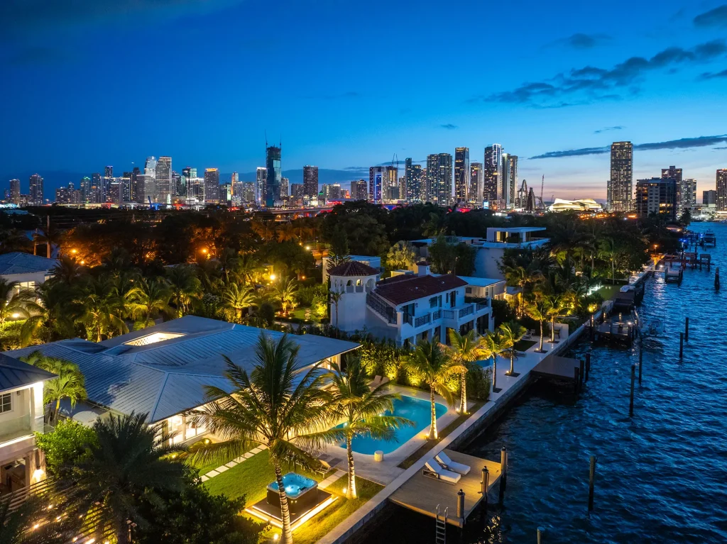 Aerial view of Villa Venetian on the bay with the Miami skyline at dusk, Venetian Islands, Miami Beach
