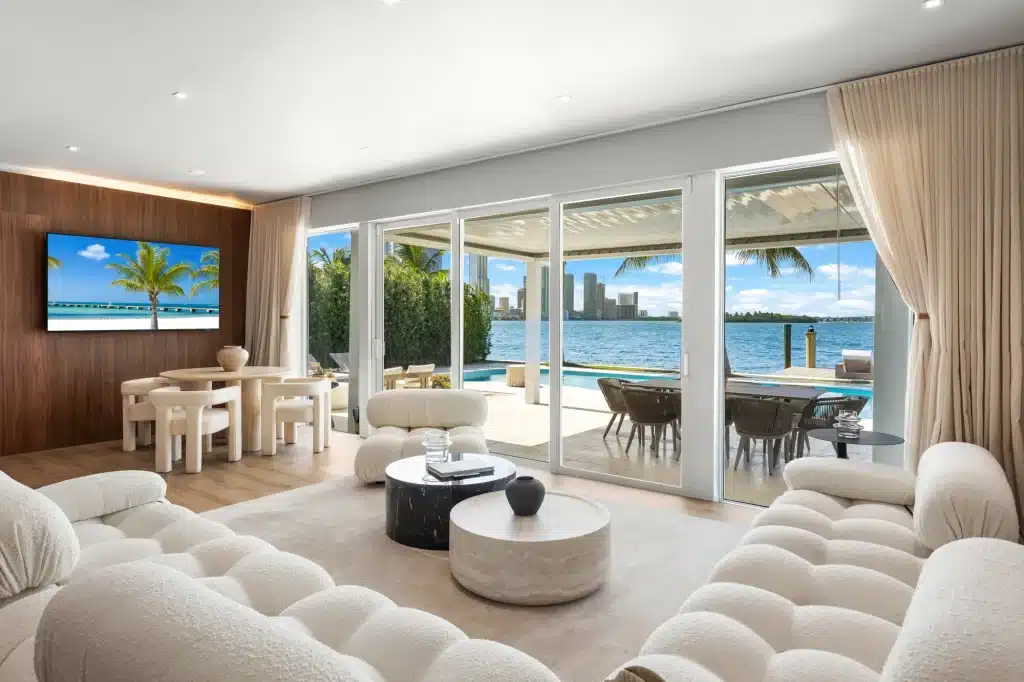 Living room with glass doors opening to the pool and bay, Villa Venetian, Venetian Islands, Miami Beach