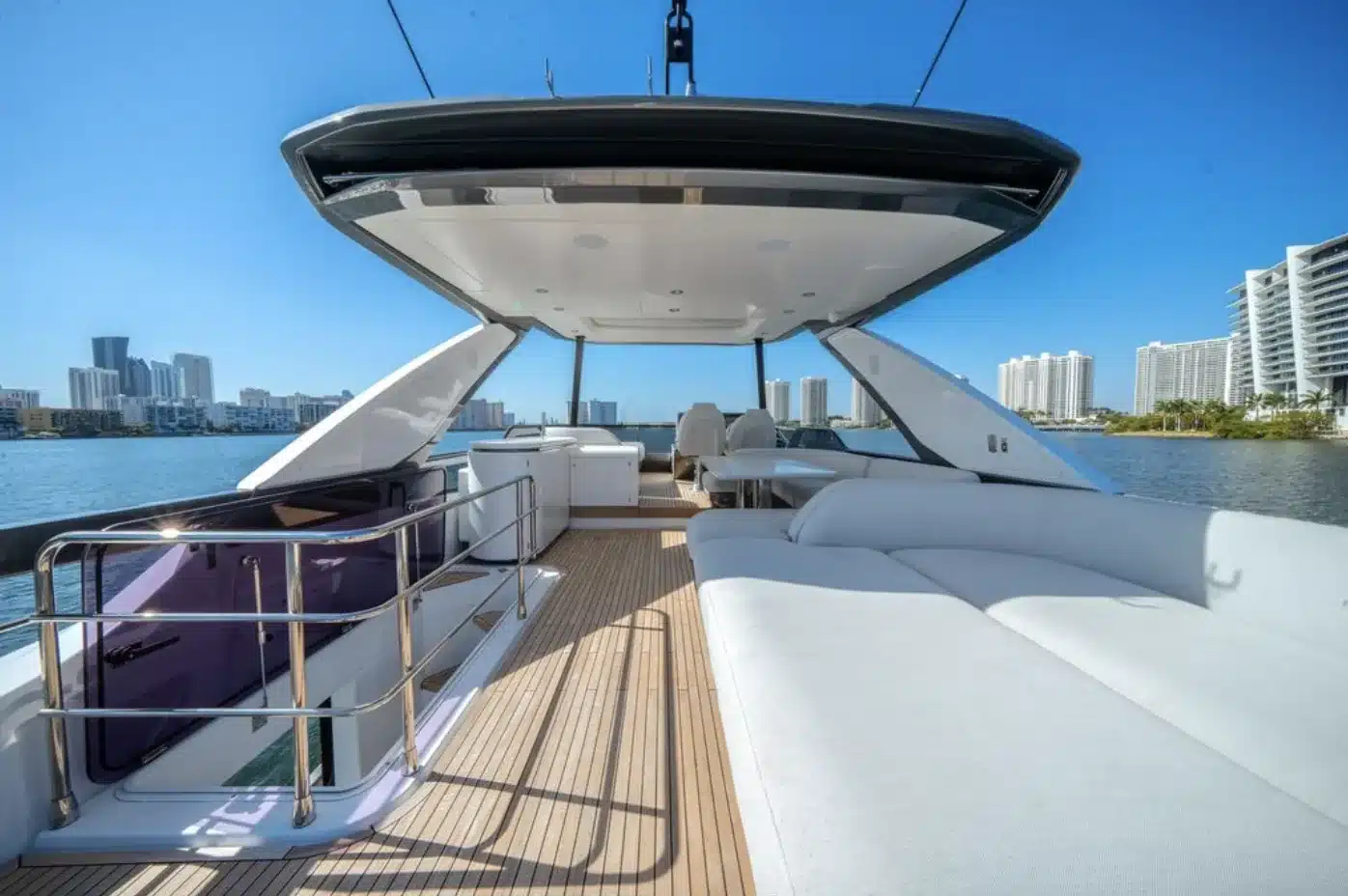 Flybridge lounge with white sun pads and the Miami Beach skyline on the 68 foot Azimut Fly yacht