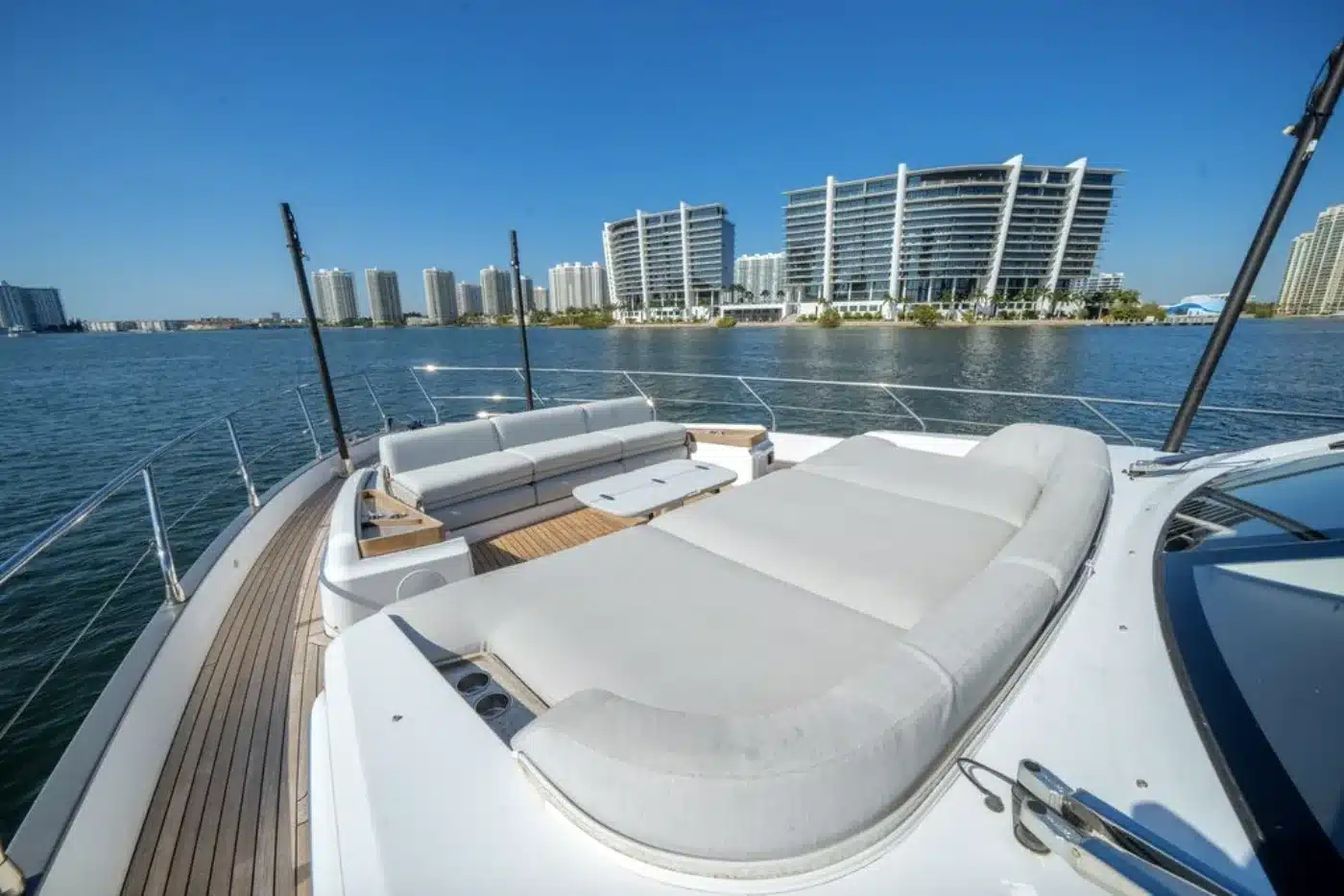 Flybridge sun pads on the 68 foot Azimut Fly yacht with waterfront towers behind