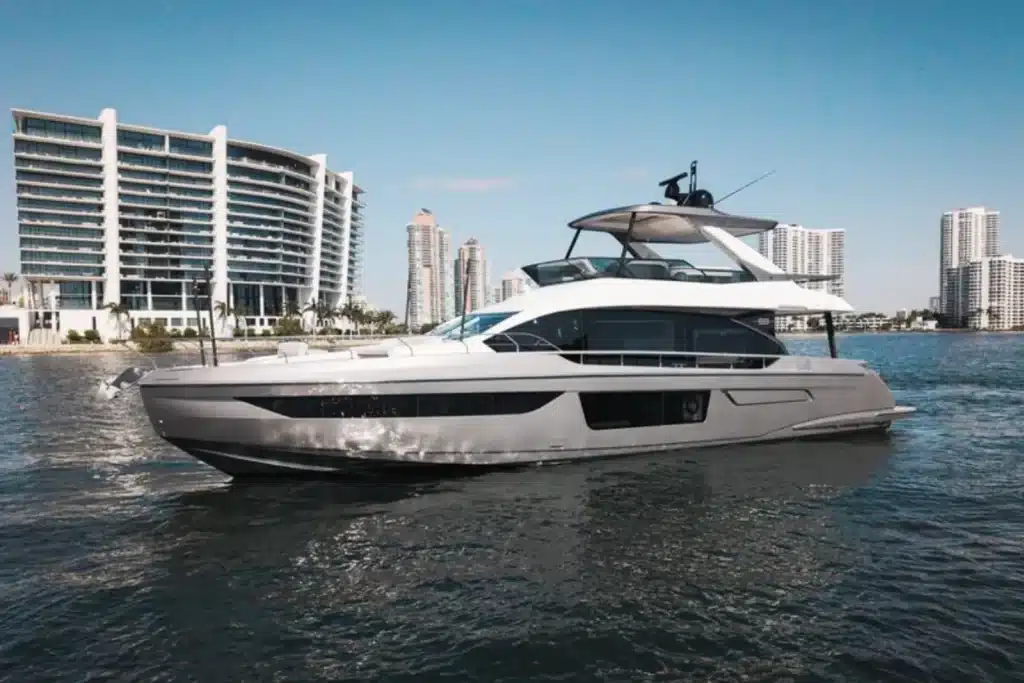Luxury motor yacht on a Miami waterway with high-rise buildings in the background