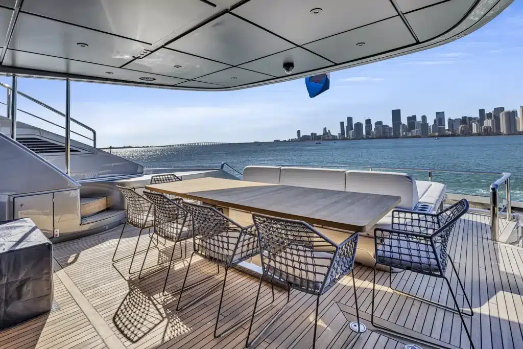 Private dining table set on a deck facing the Miami skyline across Biscayne Bay