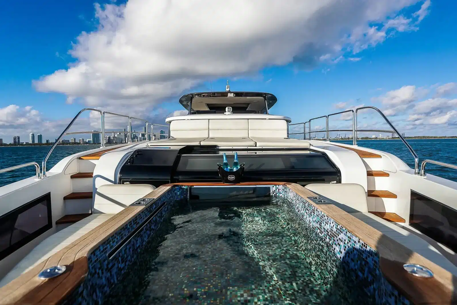 Glass bottom hot tub on the bow of the 88 foot Sirena yacht under a blue Miami sky