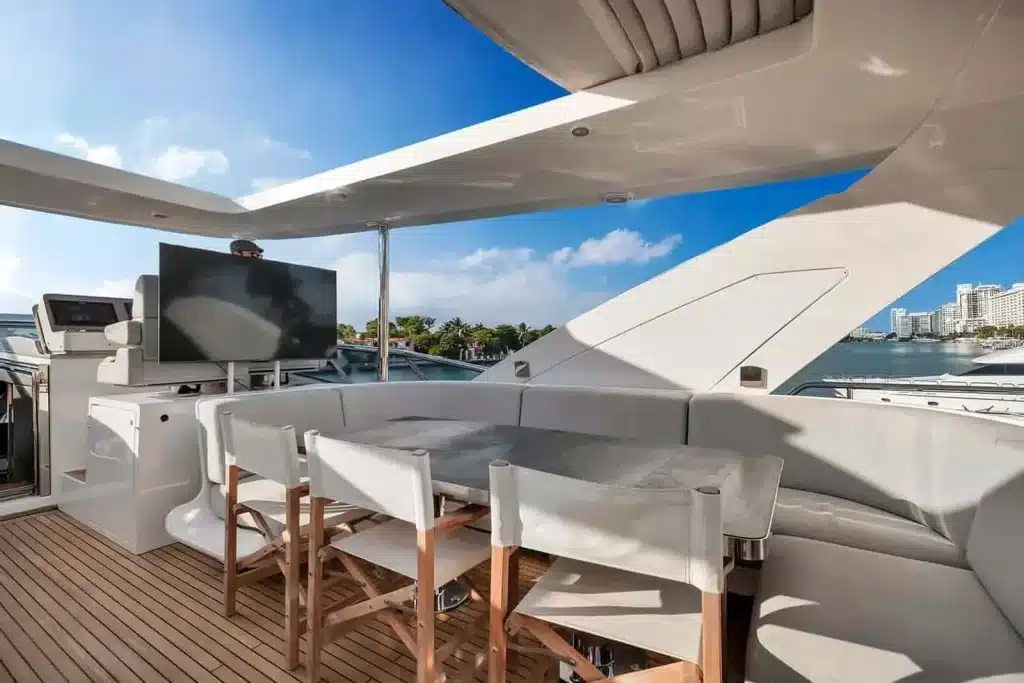 Dining table set on a yacht deck under a clear blue sky in Miami